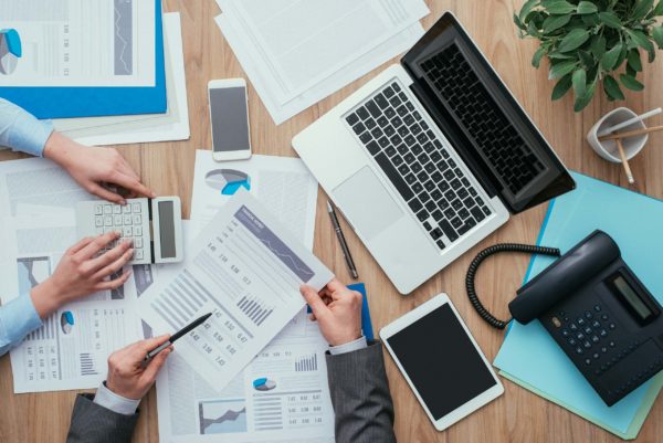 Business team working at office desk and analyzing financial reports, finance and accounting concept, top view